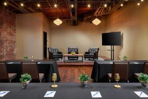 a conference room with tables and chairs and a tv at The Sessions Hotel, Bristol, a Tribute Portfolio Hotel in Bristol