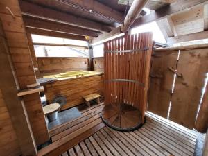 an inside view of a wooden room with a large wheel at Casa Royal - Schönes Blockhaus mit Außensauna und beheizbarem Whirl-Pool in Sankt Englmar +22 photos