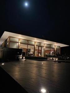 a large building with a lot of windows at night at Casa de campo in Valdivia