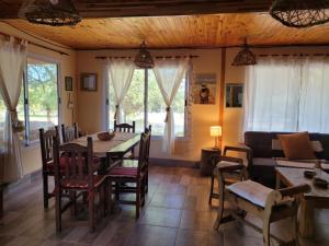 a dining room with a table and chairs and a couch at CASA PARA 10 PERSONAS, CAFAYATE in Cafayate
