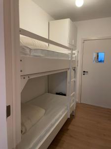 a room with two bunk beds and a door at Fully renovated studio with nice view! in Nieuwpoort