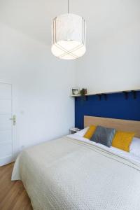 Schlafzimmer mit einem großen Bett mit blauem Kopfteil in der Unterkunft Beautiful cozy apartment for 2 people in Prag
