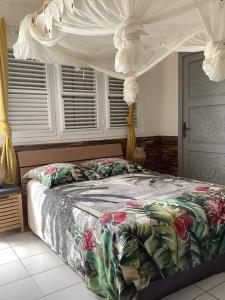 a bedroom with a bed with a canopy at Maison de vacances in Sainte-Anne