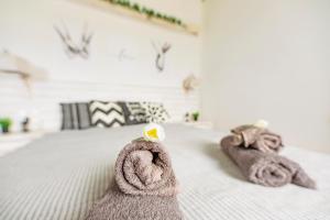 a bedroom with a bed with towels on it at Opus studio in Agios Stefanos