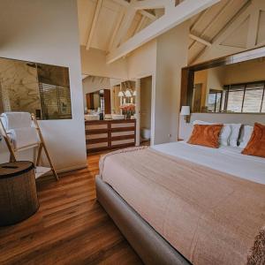 a bedroom with a large bed and a bathroom at Quinta da Azenha in Amarante