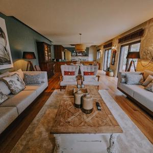 a living room with couches and a coffee table at Quinta da Azenha in Amarante