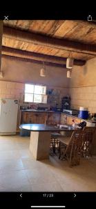 a large kitchen with a table and chairs in it at Siwa Desert Home in ‘Izbat Ţanāţī