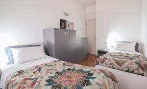 a bedroom with two beds and a dresser in it at Lario Elegante in Menaggio