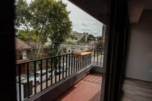 a balcony with a view of a city at Departamento del río Paraná de las Palmas in Campana