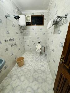 a bathroom with a toilet and a sink at Riya Villa - Entire Villa (Kaashi Flora) in Varanasi