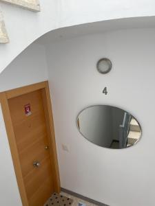 a round mirror on a wall next to a door at Torrenostra Sea Dream in Torreblanca +26 photos