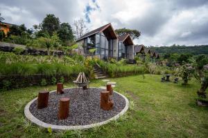 a house with a fire pit in the yard at Mountain Peak Kintamani in Kintamani
