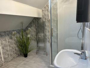 a bathroom with a sink and a shower at 5 Bedroom, 2 bath Leeds Hideaway Haven in Headingley