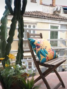 a chair with a colorful pillow on a balcony at Ollerías 35 by Nagoa Homes in Málaga