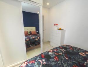 a bedroom with a bed and a large mirror at Ollerías 35 by Nagoa Homes in Málaga
