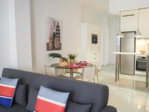 a living room with a couch and a table at Ollerías 35 by Nagoa Homes in Málaga