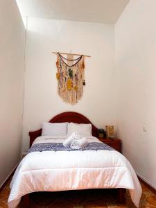 a bedroom with a bed with a towel on it at CASONA ALBARELO in Puebla