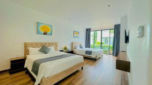 Postel nebo postele na pokoji v ubytování Aria Resort S9 - Hoàng My Villa