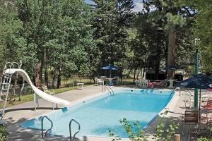 a swimming pool with a slide in a park at Nicky's Resort in Estes Park