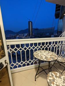 a balcony with a table and chairs and a view at Spiranca Apartments & Rooms in Tirana