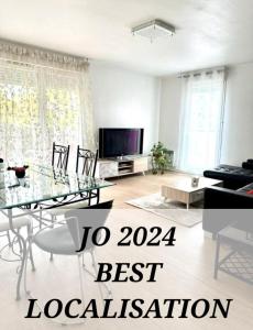 a living room with a glass table and a television at BIG logement , JO2024, stade de France, PARIS, métro , parking gratuit in Saint-Denis