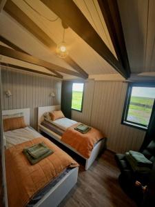 a bedroom with two beds in a room at Green Farm Stay with private hot tub in Hvolsvöllur