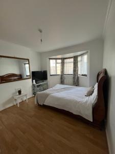 a bedroom with a large bed and a window at Charlton, Greenwich Service Apartment in London