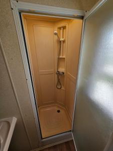 a shower in a bathroom with the door open at Caravan holiday let 2 bedroom happy days SOUTH chapel saint Leonards 05 in Chapel Saint Leonards
