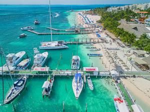an aerial view of a harbor with boats in the water at Walk barefoot to beach! Two bathrooms! Entire private sailboat in Isla Mujeres