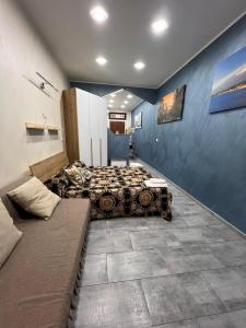 a bedroom with two beds and a couch at Mary House Apartments in Catania