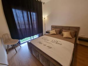 a bedroom with a large bed with a bedspread with the words happy anniversary at Luxueux appartement Golf City Rez-de-Jardin et Piscine in Marrakesh