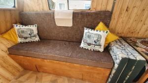 a couch in the back of a tiny house at Trailor Escape GLAMPING POD - our converted horse box at Nelson Park Riding Centre - Birchington, Margte, Thanet, Ramsgate, Broadstairs, Sandwich, Herne Bay in Birchington
