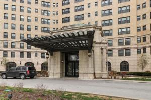 a car parked in front of a large building at Enchanting 1BR Apartment in Hyde Park - Windermere 401 in Chicago