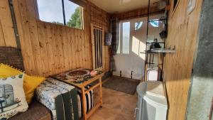 a room with a couch and a table in a room at Trailor Escape GLAMPING POD - our converted horse box at Nelson Park Riding Centre - Birchington, Margte, Thanet, Ramsgate, Broadstairs, Sandwich, Herne Bay in Birchington