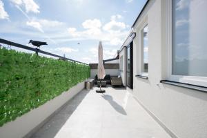 a balcony with a cow on the wall of a house at Lifestyle Penthouse Apartment in Ludwigshafen am Rhein