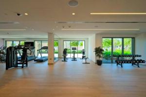 a gym with treadmills and machines in a room at Burj Royale 2 Bed with Burj Khalifa View in Dubai