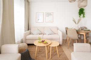 a living room with a couch and a table at Lifestyle Penthouse Apartment in Ludwigshafen am Rhein