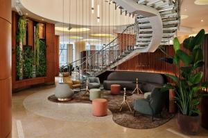 a lobby with a spiral staircase in a building at The Westin Warsaw in Warsaw