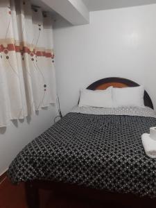 Rúm í herbergi á Hostal Ayllu