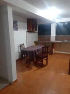 a kitchen with a table and chairs in a room at Hostal Ayllu in Urubamba