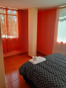 Rúm í herbergi á Hostal Ayllu