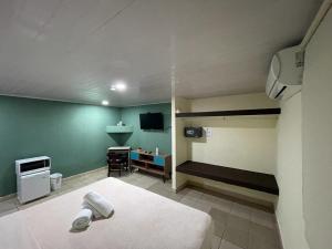 a bedroom with a bed and a tv in a room at HOSTAL IBRAIS in Panama City