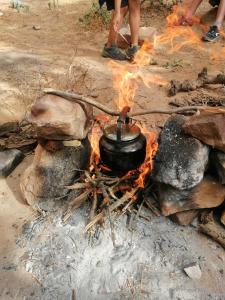 a pot on top of a camp fire at Dana local life Eco Lodge in Dana