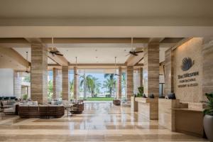 a lobby at the mgm resort with palm trees at The Westin Puntacana Resort in Punta Cana
