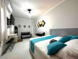 a bedroom with a bed with a teddy bear on it at Kitnet - São Vicente - Itararé in São Vicente