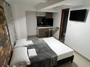 Rúm í herbergi á Hotel Coffee Real Pereira