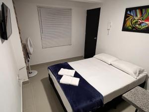 Rúm í herbergi á Hotel Coffee Real Pereira