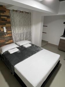 Rúm í herbergi á Hotel Coffee Real Pereira