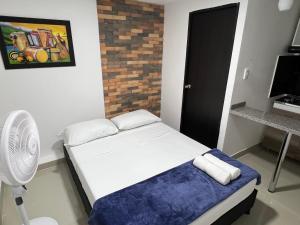 Rúm í herbergi á Hotel Coffee Real Pereira