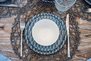 un tavolo con un piatto e una forchetta e un coltello di Corali Studios a Lefkos Karpathou